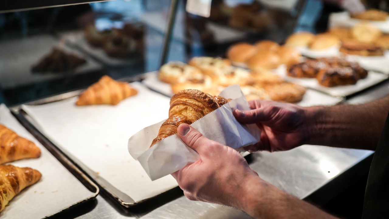 Greaseproof sheets being used in UK bakery wrapping fresh baked goods - Wabs Print