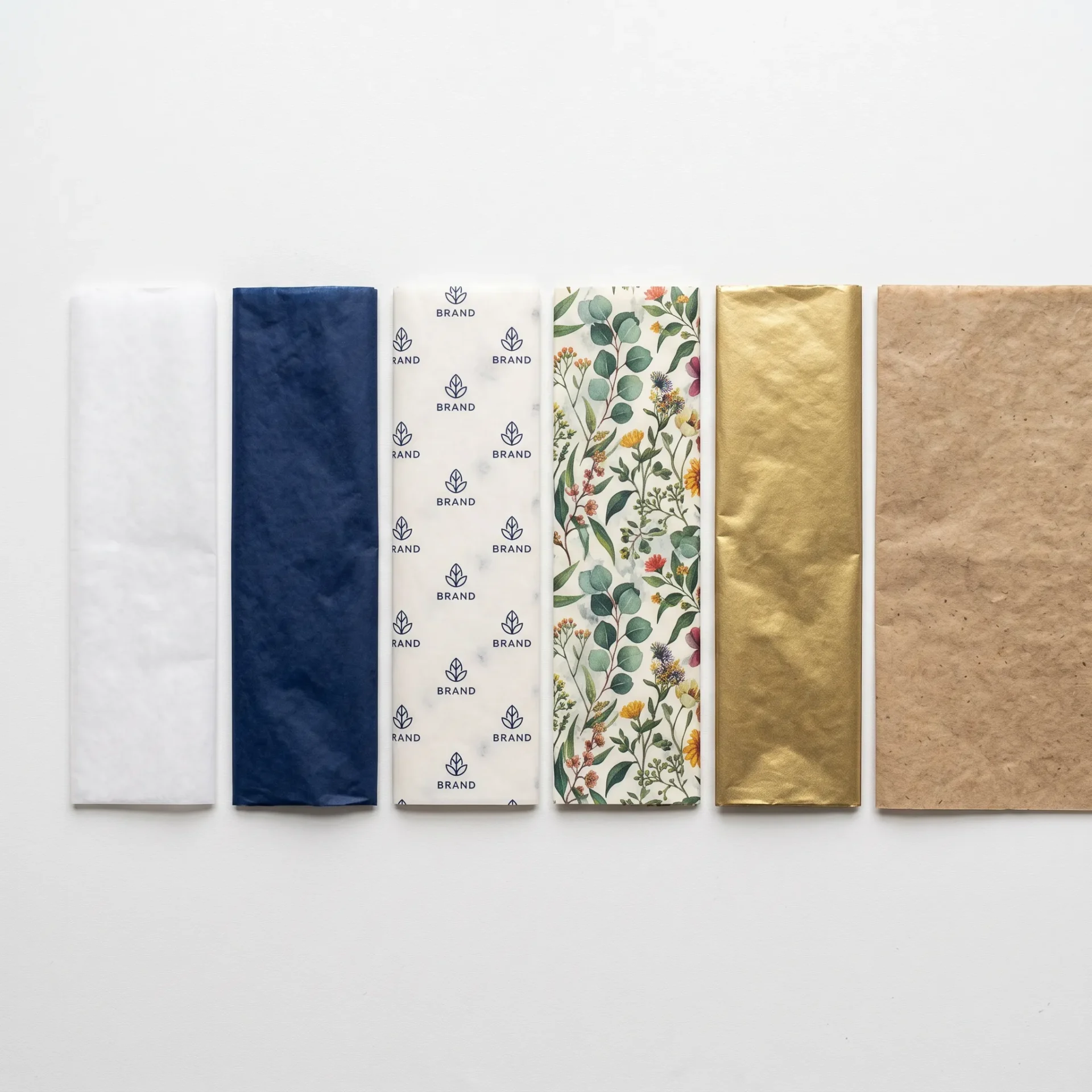 Six tissue paper types comparison flat lay plain white solid colour printed metallic kraft UK | Wabs Print